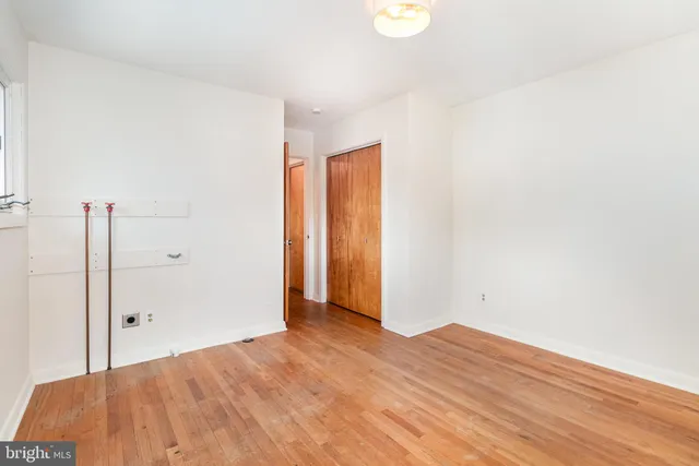 a view of a room with wooden floor and window