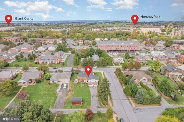 an aerial view of residential houses with outdoor space