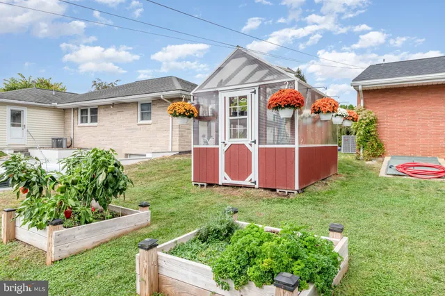 a view of a house with a yard and a garden