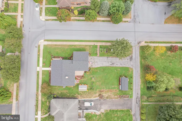 an aerial view of a house with a yard