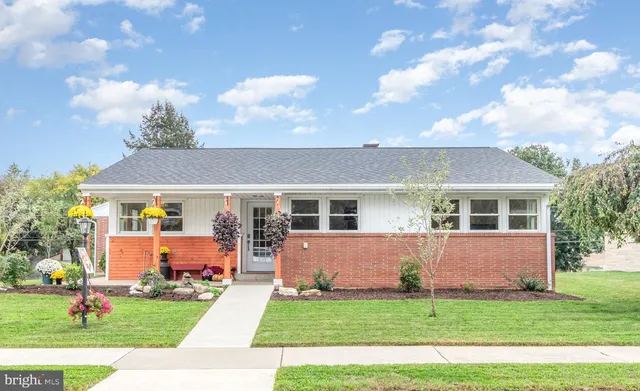 a front view of house with yard and green space