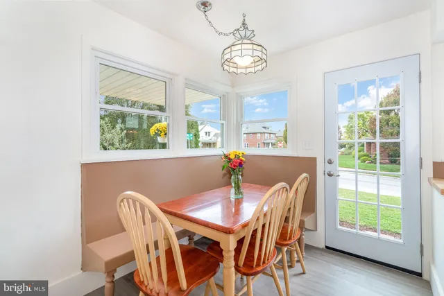 a view of a dining room with furniture a chandelier and wooden floor
