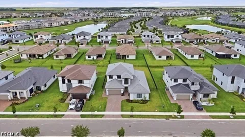 an aerial view of multiple houses with yard