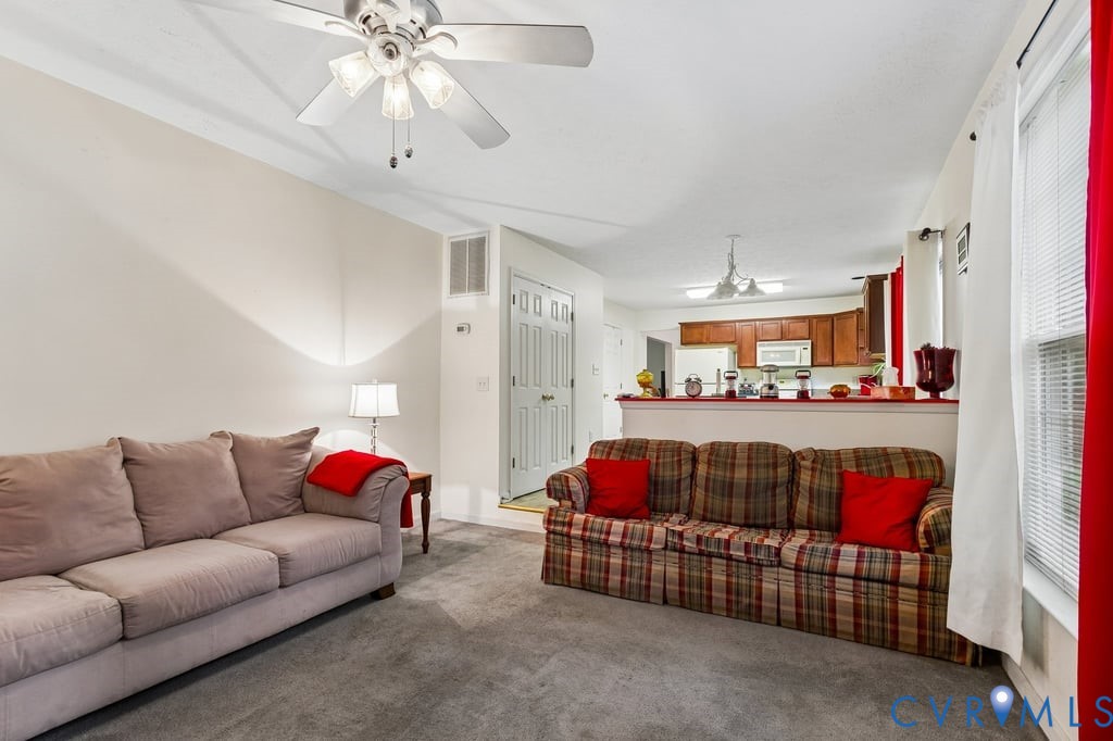 83 Albertson Court Ruther Glen, VA 22546 - Photo 14 of 25 Carpeted living area with a ceiling fan light fixt