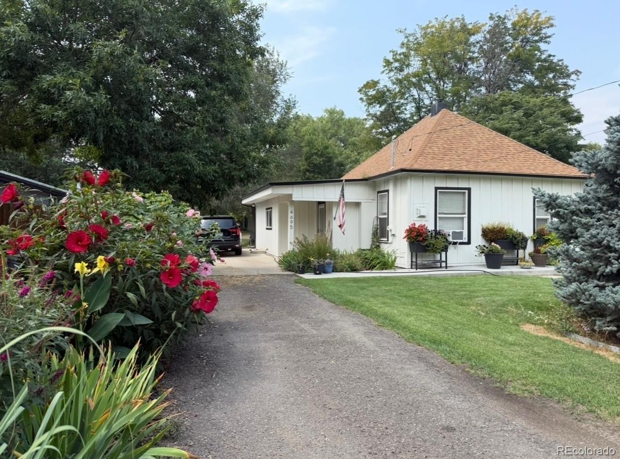 a front view of a house with a yard and fountain