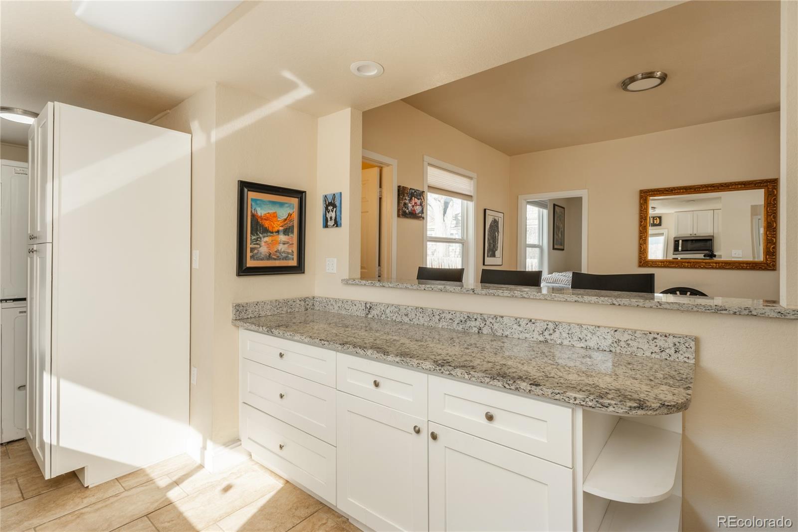 4695 Parfet Street Wheat Ridge, CO 80033 - Photo 14 of 46 a spacious bathroom with a granite countertop sink and a mirror