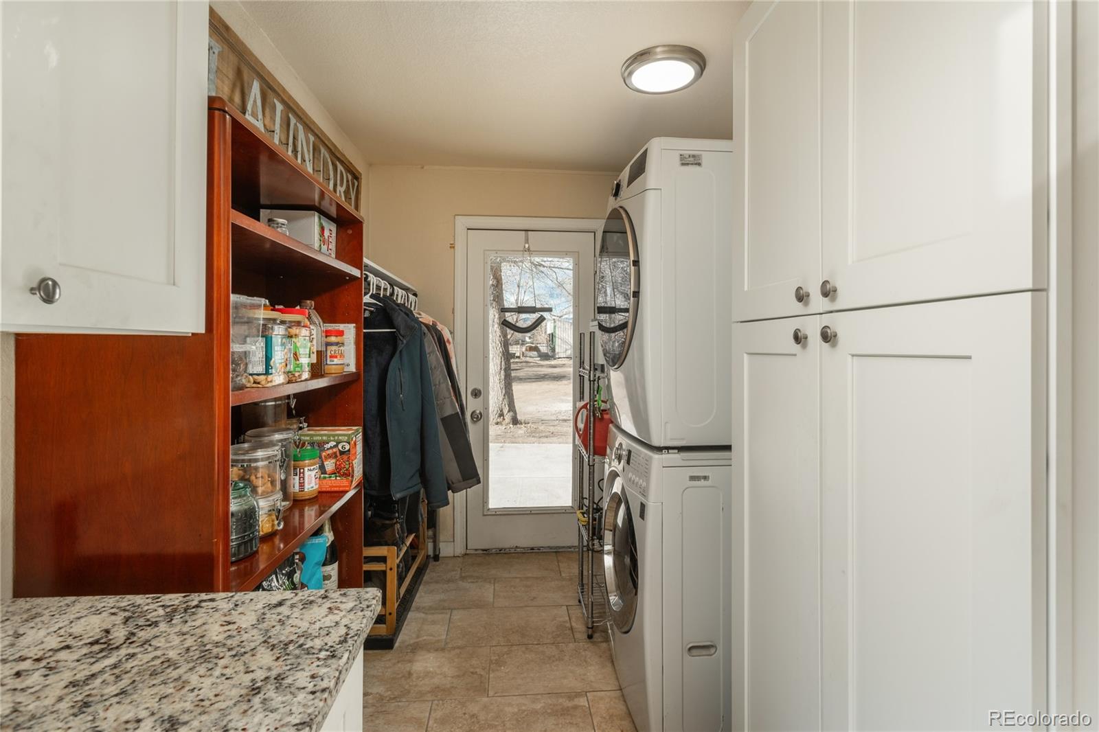 4695 Parfet Street Wheat Ridge, CO 80033 - Photo 15 of 46 a view of walk in closet with clothes and shoes