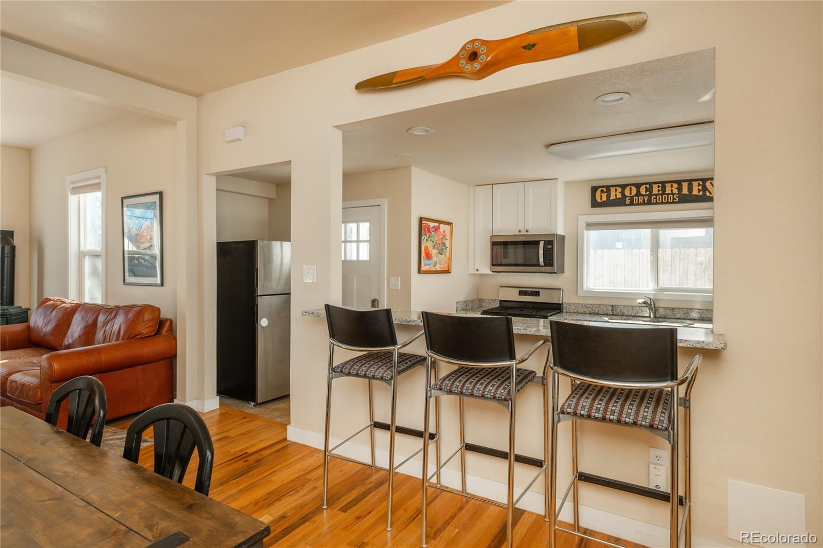 4695 Parfet Street Wheat Ridge, CO 80033 - Photo 16 of 46 a living room with furniture and a wooden floor
