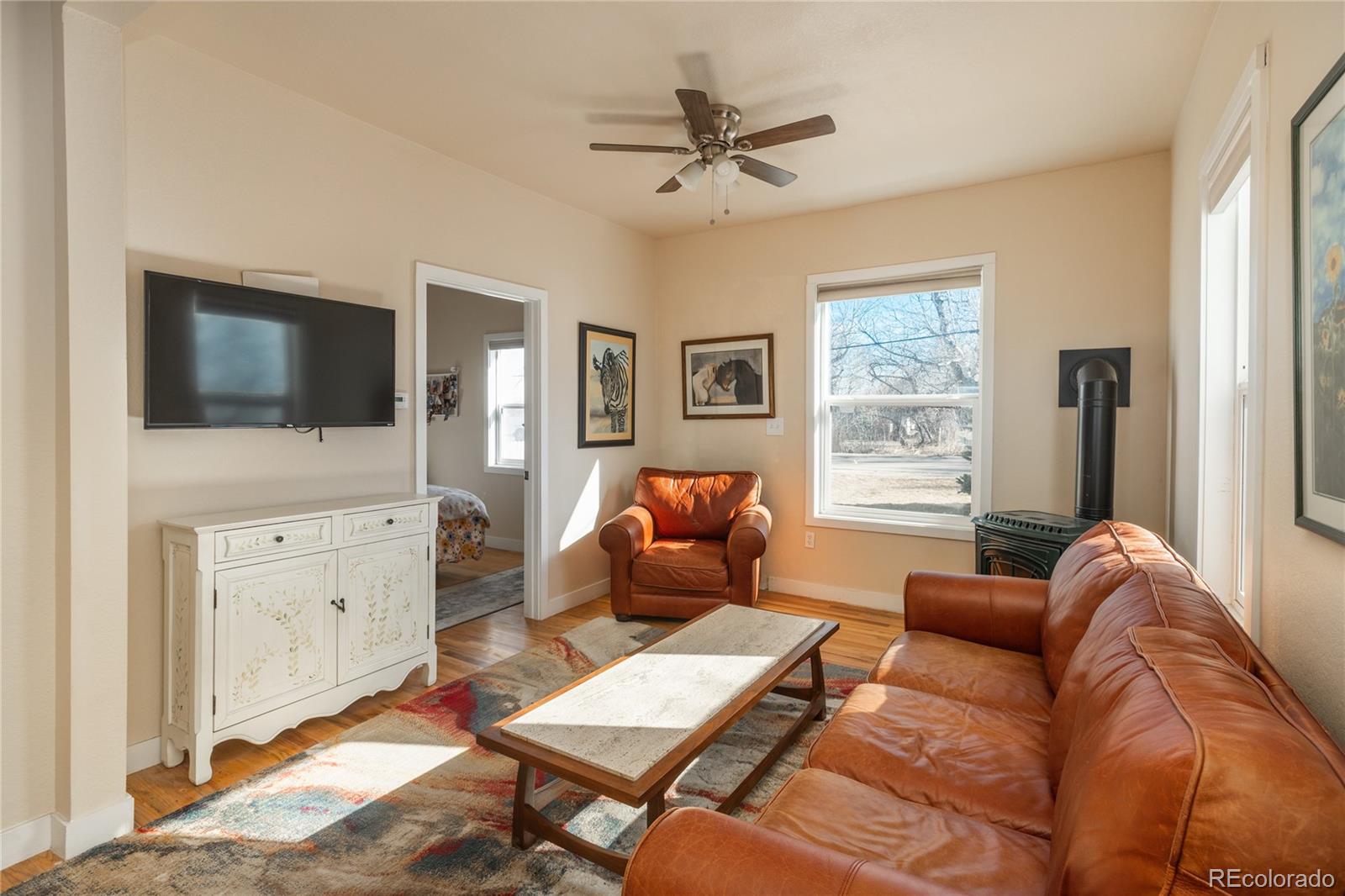 4695 Parfet Street Wheat Ridge, CO 80033 - Photo 17 of 46 a living room with furniture and a flat screen tv