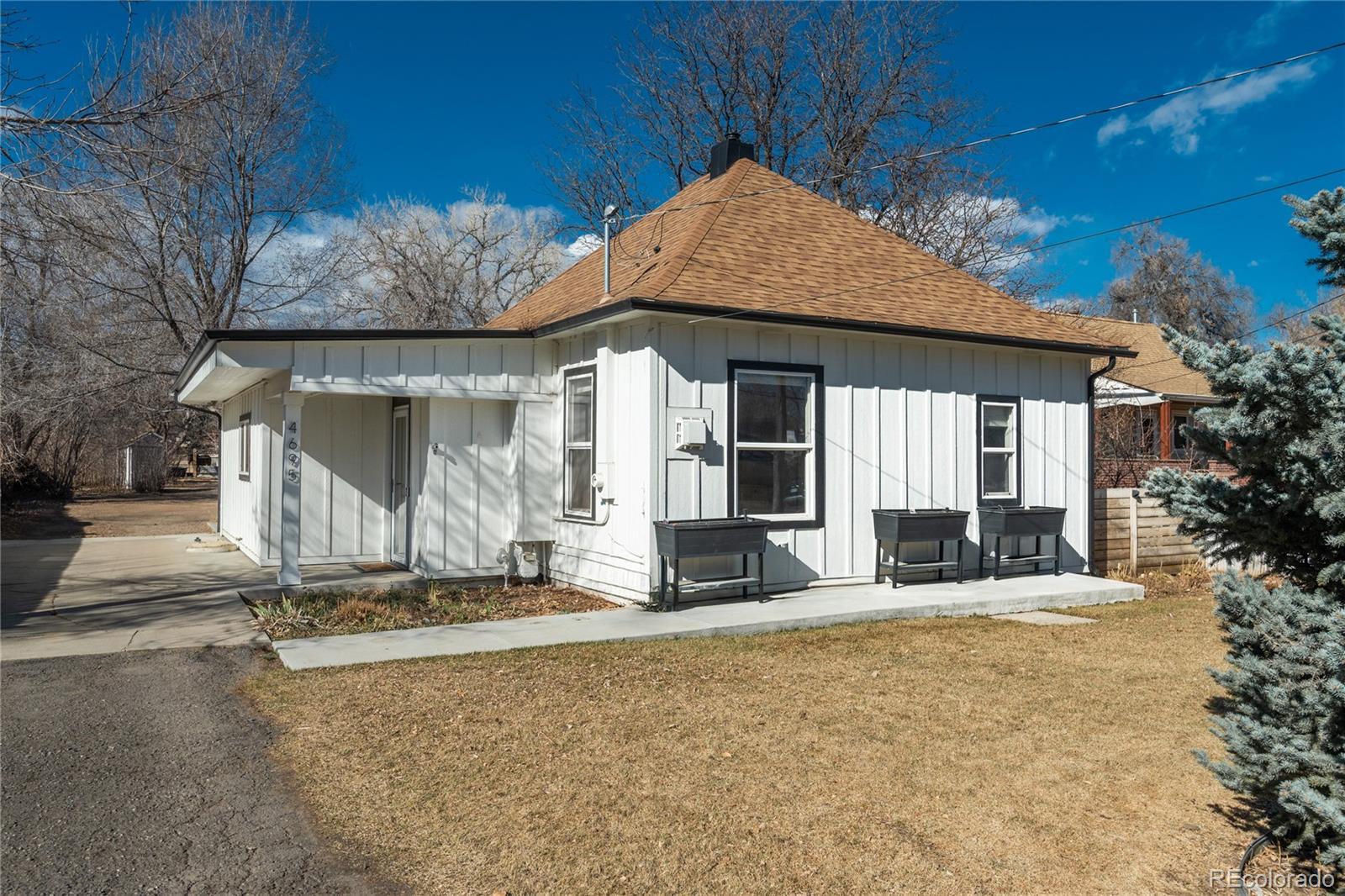 4695 Parfet Street Wheat Ridge, CO 80033 - Photo 2 of 46 a front view of a house with a yard