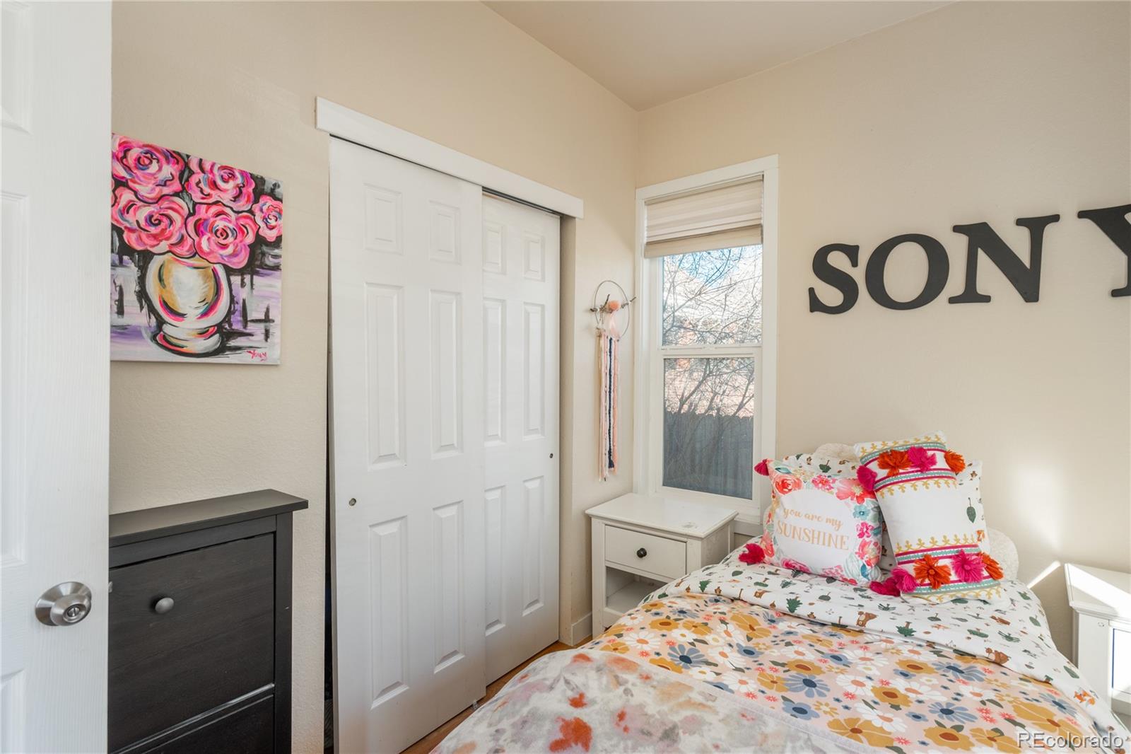 4695 Parfet Street Wheat Ridge, CO 80033 - Photo 21 of 46 a bedroom with a bed and cabinets