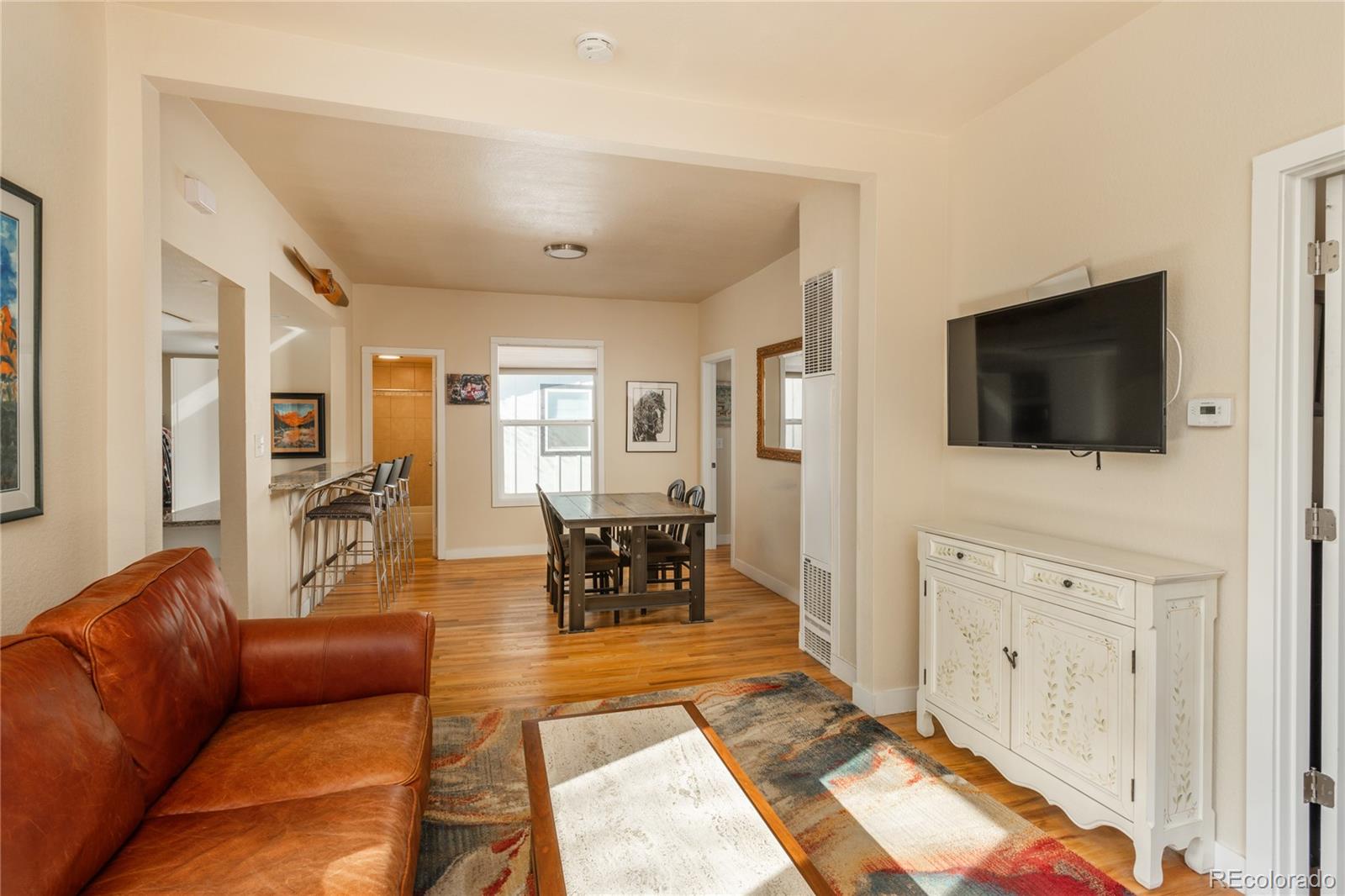 4695 Parfet Street Wheat Ridge, CO 80033 - Photo 23 of 46 a living room with furniture and a flat screen tv