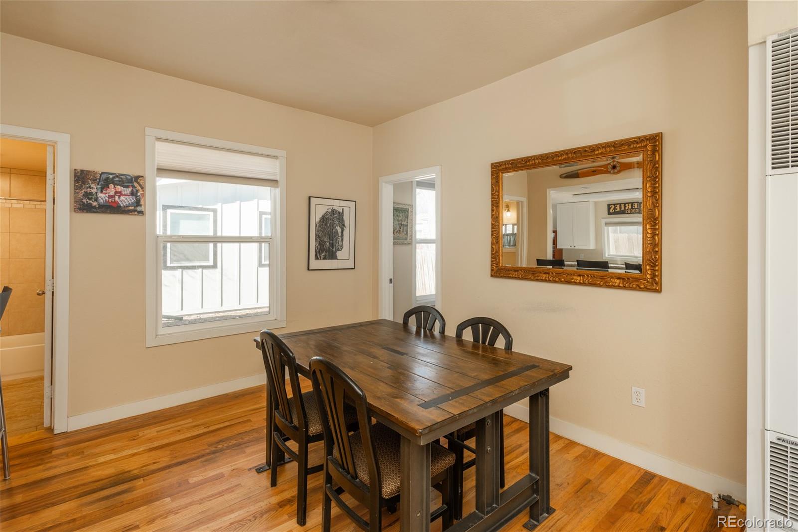 4695 Parfet Street Wheat Ridge, CO 80033 - Photo 25 of 46 a dining room with a table and chairs