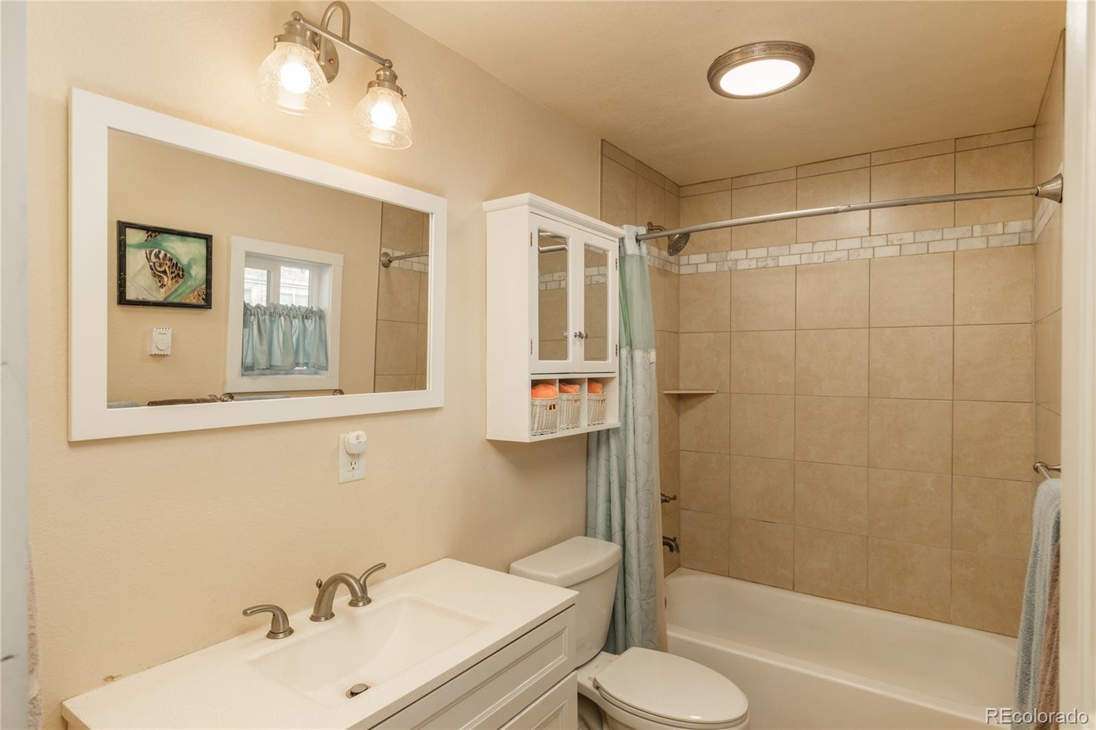 4695 Parfet Street Wheat Ridge, CO 80033 - Photo 28 of 46 a bathroom with a sink toilet and shower
