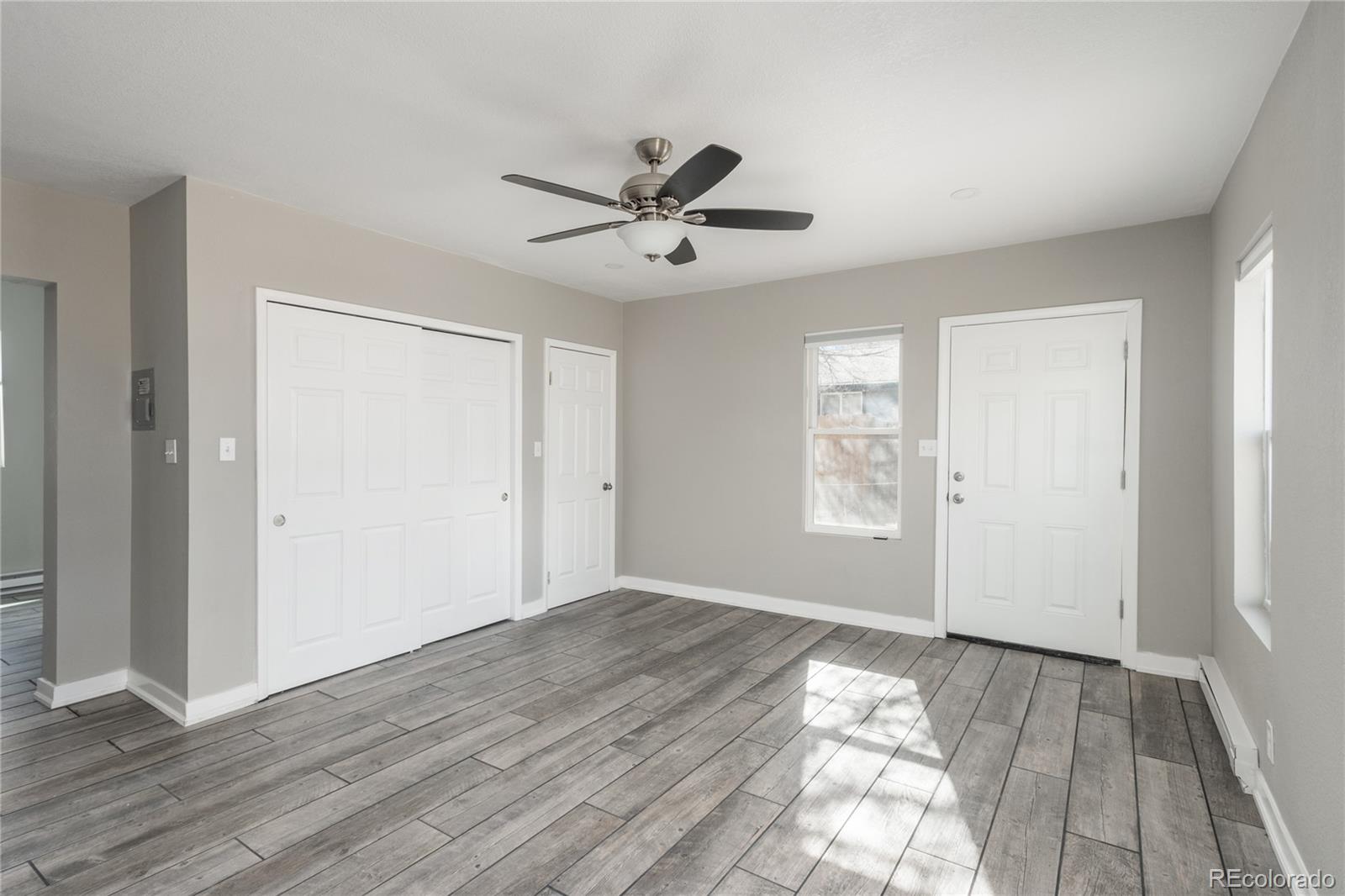 4695 Parfet Street Wheat Ridge, CO 80033 - Photo 29 of 46 a view of empty room with wooden floor and fan