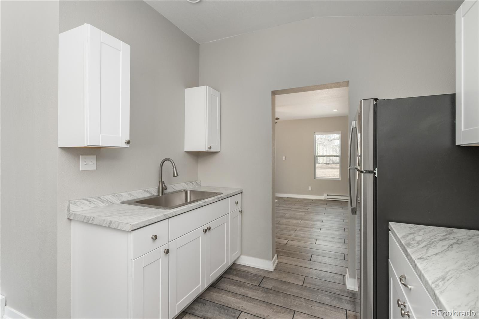 4695 Parfet Street Wheat Ridge, CO 80033 - Photo 31 of 46 a bathroom with a sink and a mirror