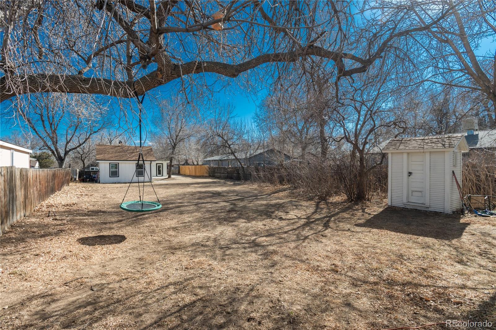 4695 Parfet Street Wheat Ridge, CO 80033 - Photo 44 of 46 a view of a yard with wooden fence