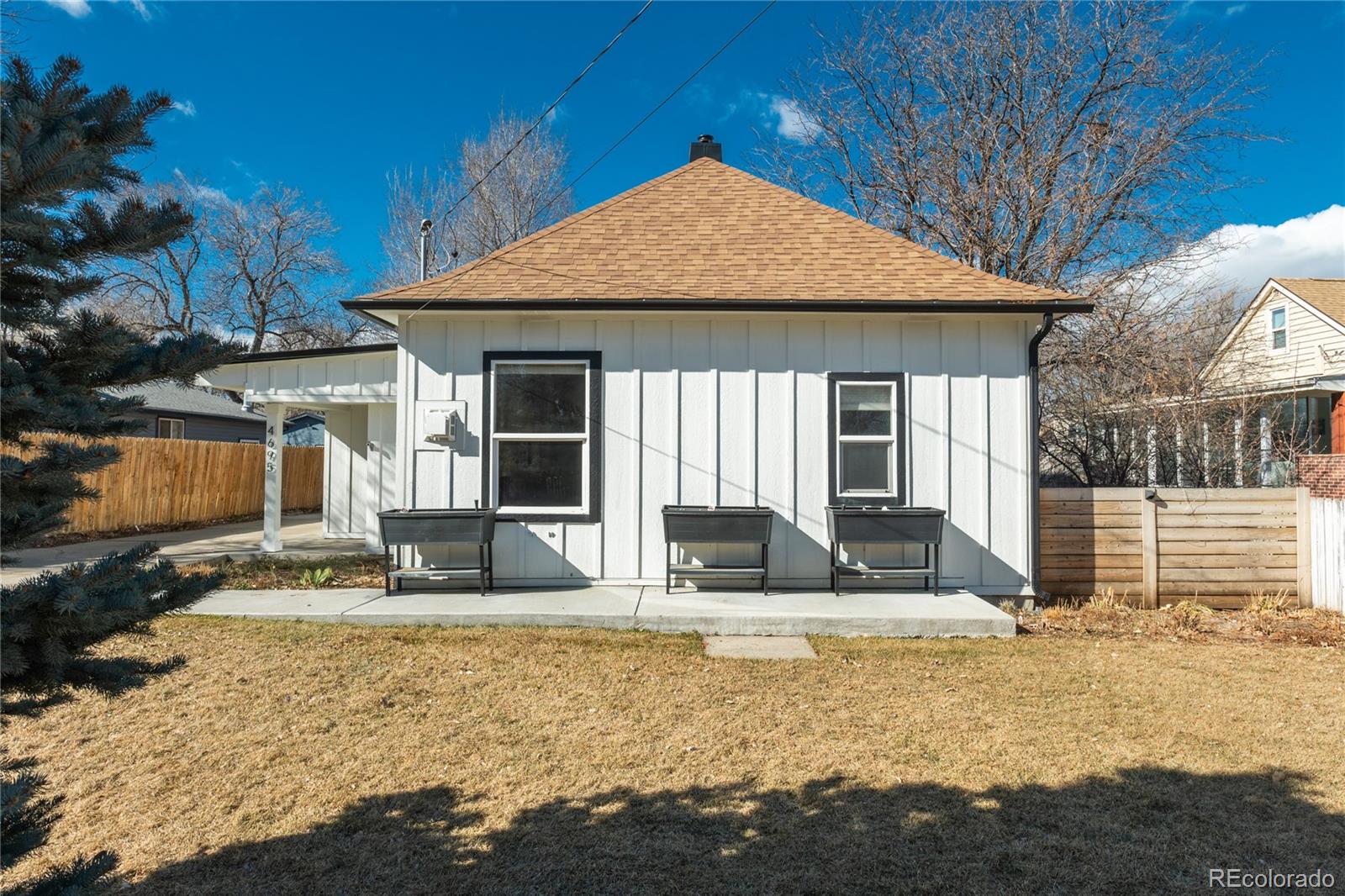 4695 Parfet Street Wheat Ridge, CO 80033 - Photo 5 of 46 a front view of a house with garden