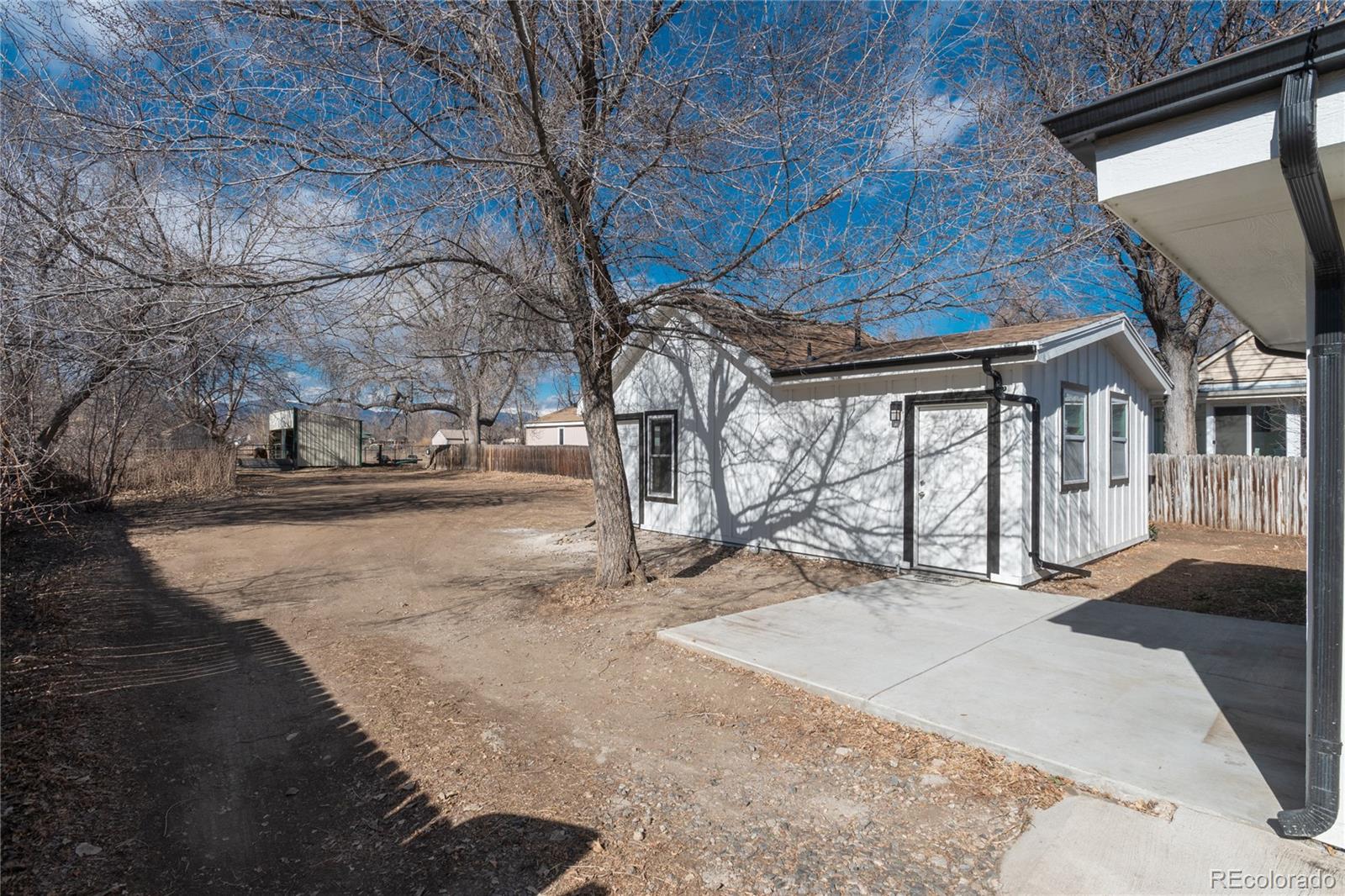 4695 Parfet Street Wheat Ridge, CO 80033 - Photo 6 of 46 a view of a house with a snow in the yard