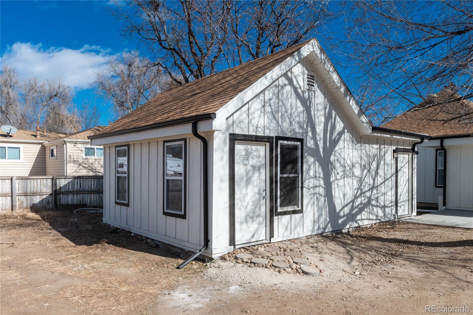 4695 Parfet Street Wheat Ridge, CO 80033 - Photo 9 of 46 a view of a house with wooden fence