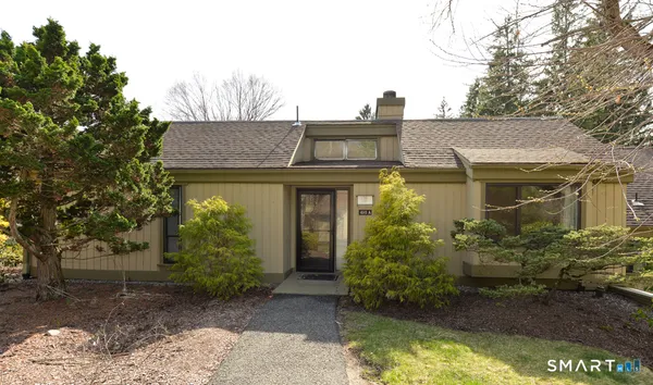 a view of a house with brick walls and potted plants