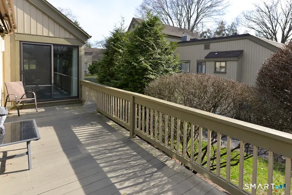 a view of balcony with wooden floor and bench