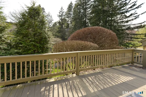 a view of balcony with wooden floor and fence