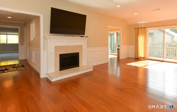 a view of a livingroom with an empty space and a fireplace