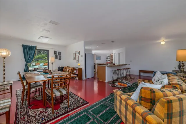 a living room with furniture a rug and a table