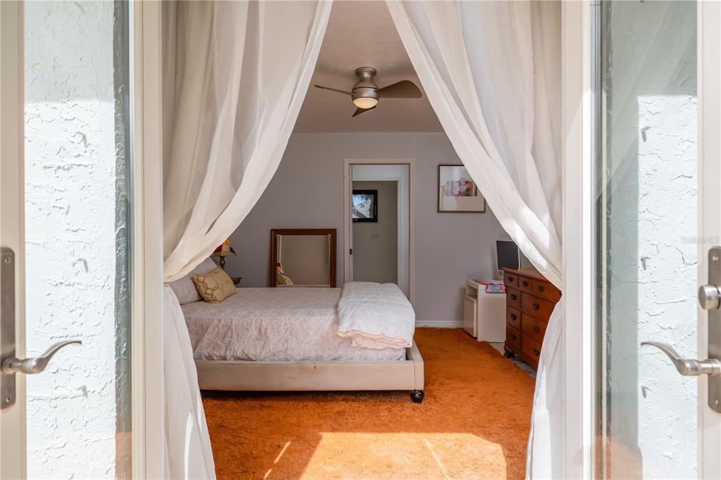 4790 Michael Lane Ponce Inlet, FL 32127 - Photo 19 of 28 a bedroom with a bed and a window