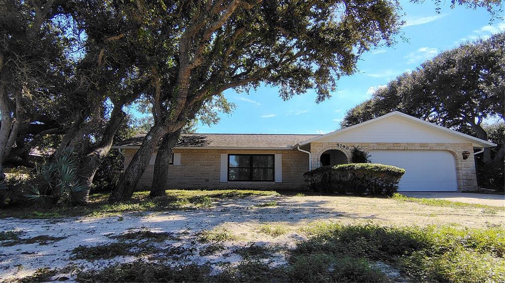 4790 Michael Lane Ponce Inlet, FL 32127 - Photo 28 of 28 a front view of house with yard and trees around