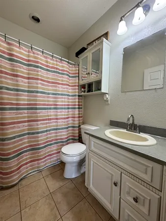 a bedroom with furniture and a chandelier fan
