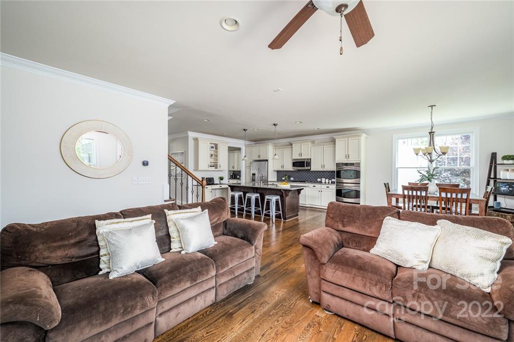 6009 Daphne Circle Fort Mill, SC 29708 - Photo 12 of 43 a living room with furniture kitchen view and a wooden floor