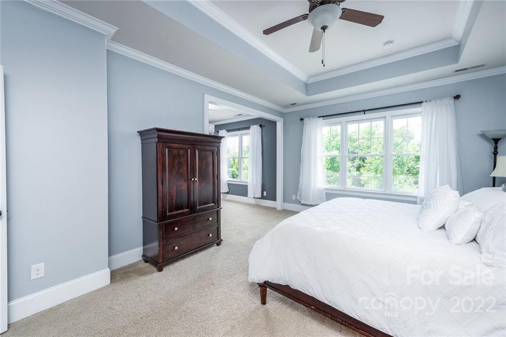 6009 Daphne Circle Fort Mill, SC 29708 - Photo 24 of 43 a spacious bedroom with a bed and a chandelier