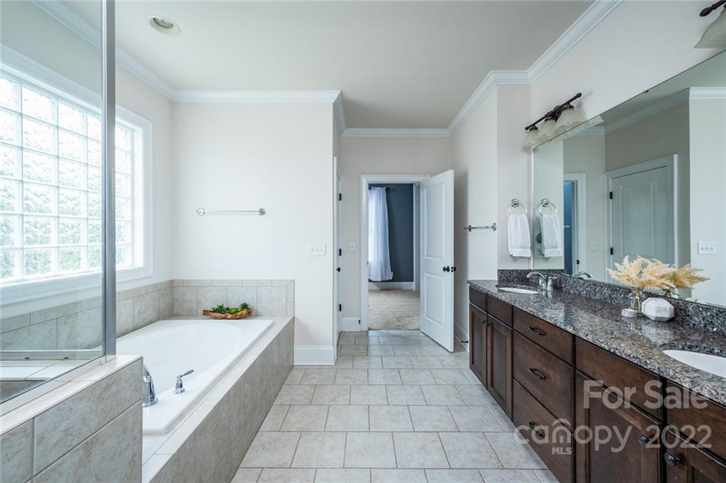 6009 Daphne Circle Fort Mill, SC 29708 - Photo 27 of 43 a spacious en suite bathroom with a granite countertop tub and 2 sink