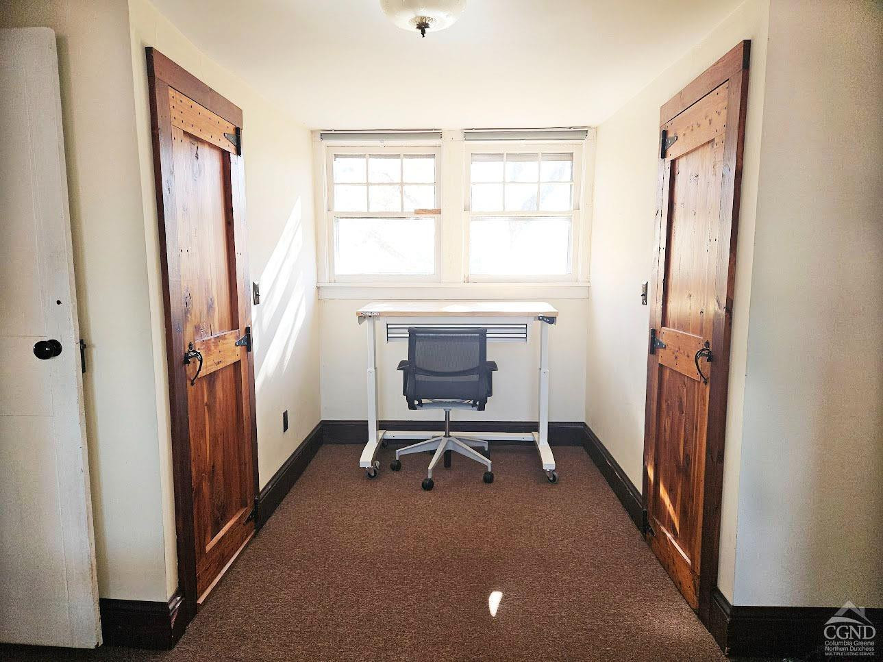 266 Fingar Road Hudson, NY 12534 - Photo 18 of 20 a view of an empty room with a fireplace and a window