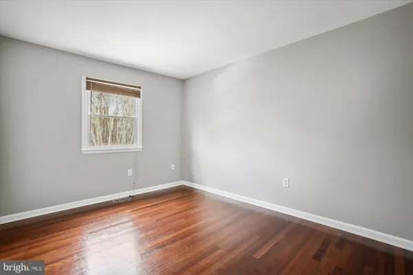 a view of a room with wooden floor and windows in it