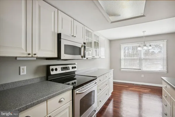 a kitchen with stainless steel appliances white cabinets and a sink
