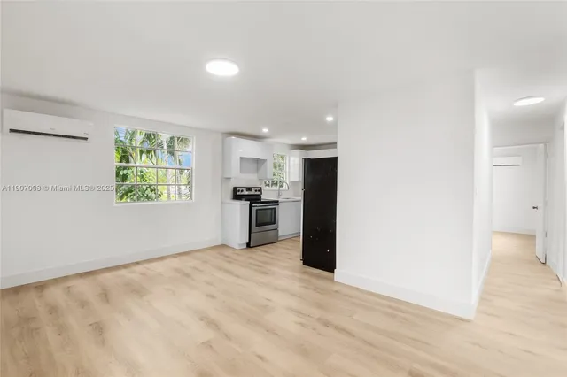 a view of kitchen with window and refrigerator