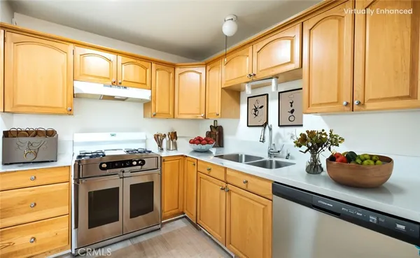 a kitchen with stainless steel appliances a stove sink microwave and cabinets