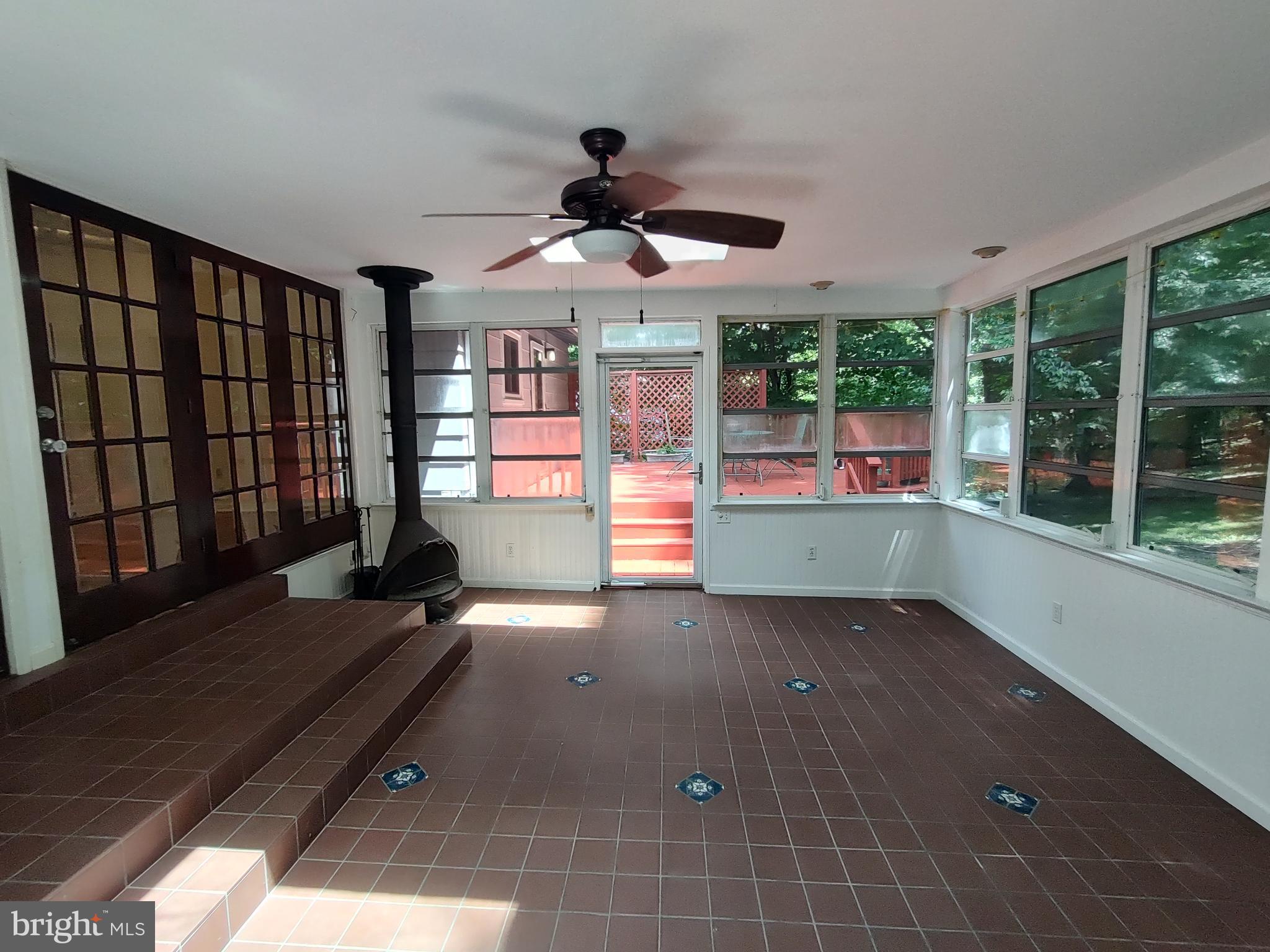 112 Claybrook Drive Silver Spring, MD 20902 - Photo 17 of 66 Sun room with ceiling fan, exit to deck.