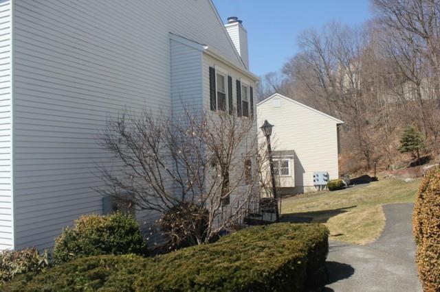 55 Mill Plain Road, Unit 202 Danbury, CT 06811 - Photo 1 of 1 a view of a house with a yard