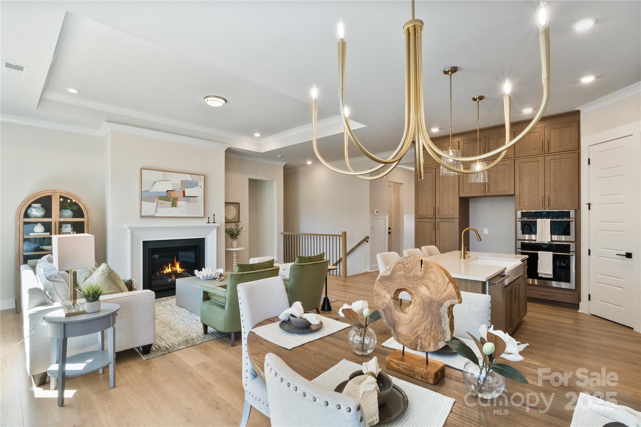 2081 Bonds Lane, Unit 27 Fort Mill, SC 29715 - Photo 5 of 46 a living room with furniture a fireplace and a chandelier