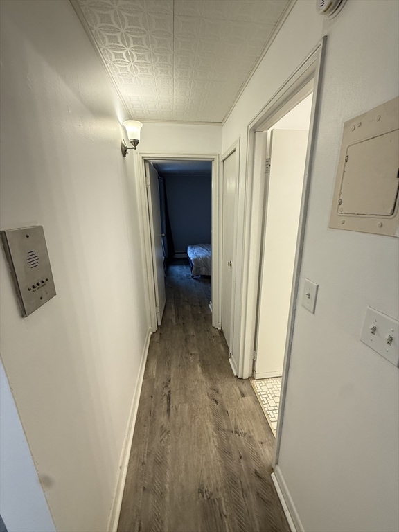 140 Kenrick Street, Unit 25 Boston, MA 02135 - Photo 7 of 12 a view of a hallway with wooden floor and staircase