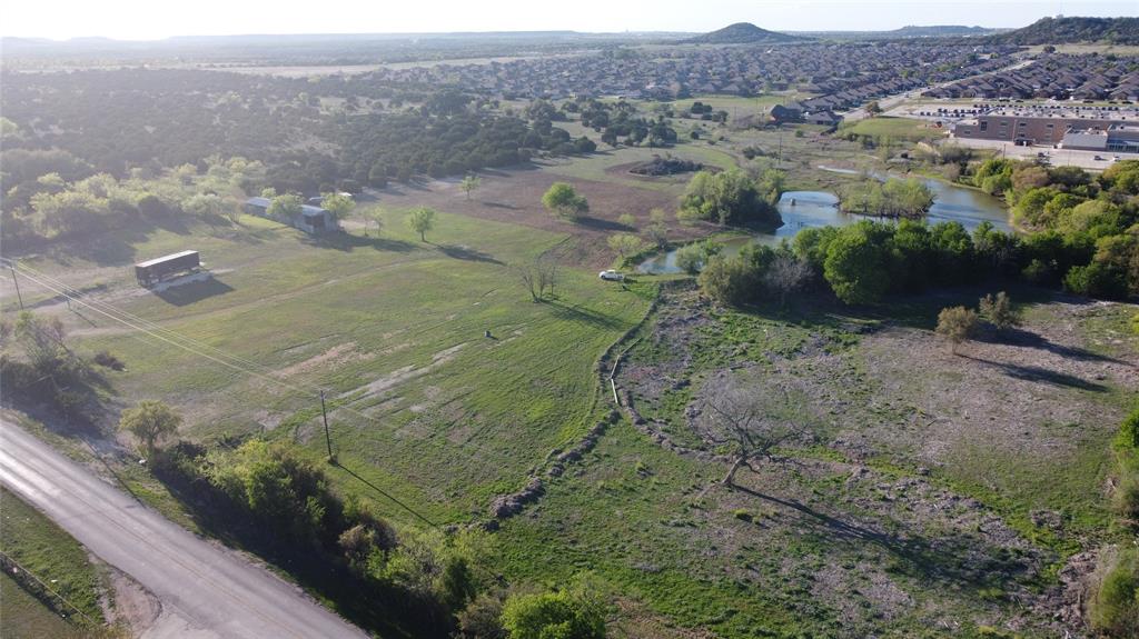 Aerial overview of property's location featuring rural landscape and a large body of water