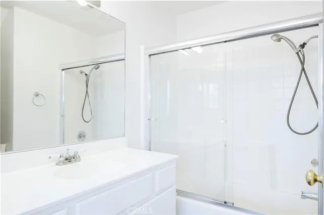 a bathroom with a shower and a sink