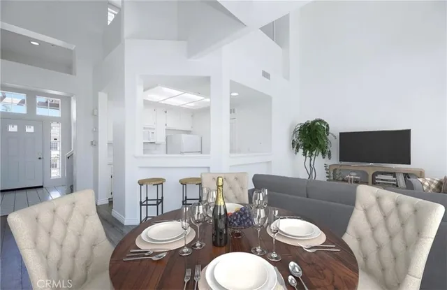 a living room with furniture a flat screen tv and a mirror