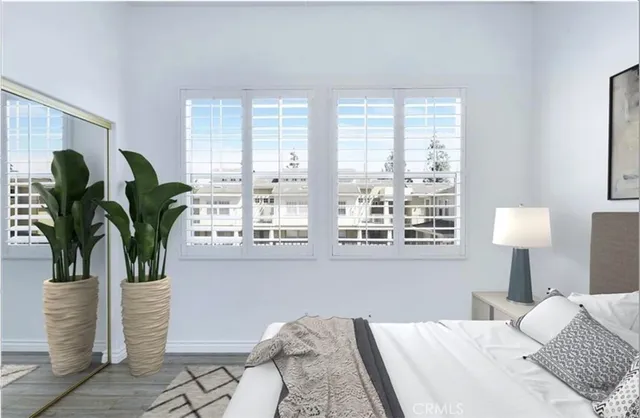 a bedroom with furniture and a potted plant