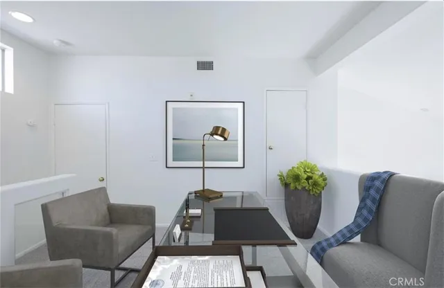 a living room with furniture and flowers