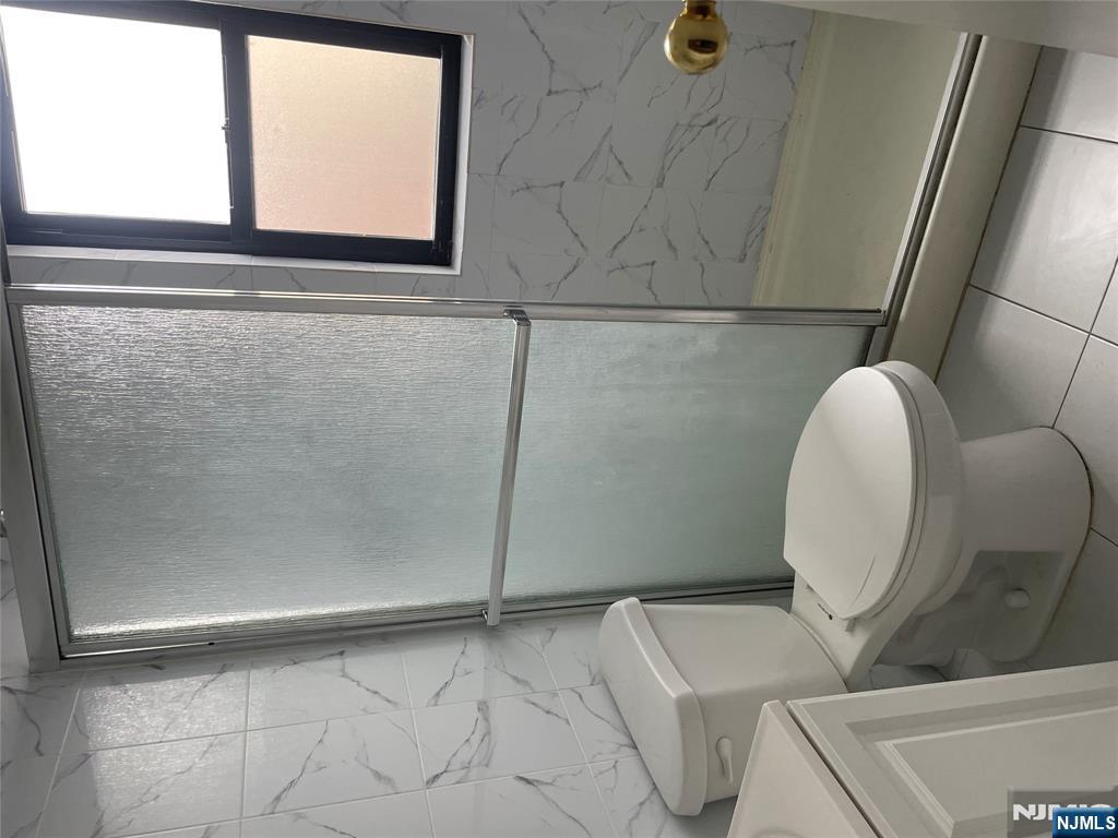 232-230 Anderson Avenue, Unit 3A Fairview, NJ 07022 - Photo 9 of 11 a bathroom with a toilet and a shower